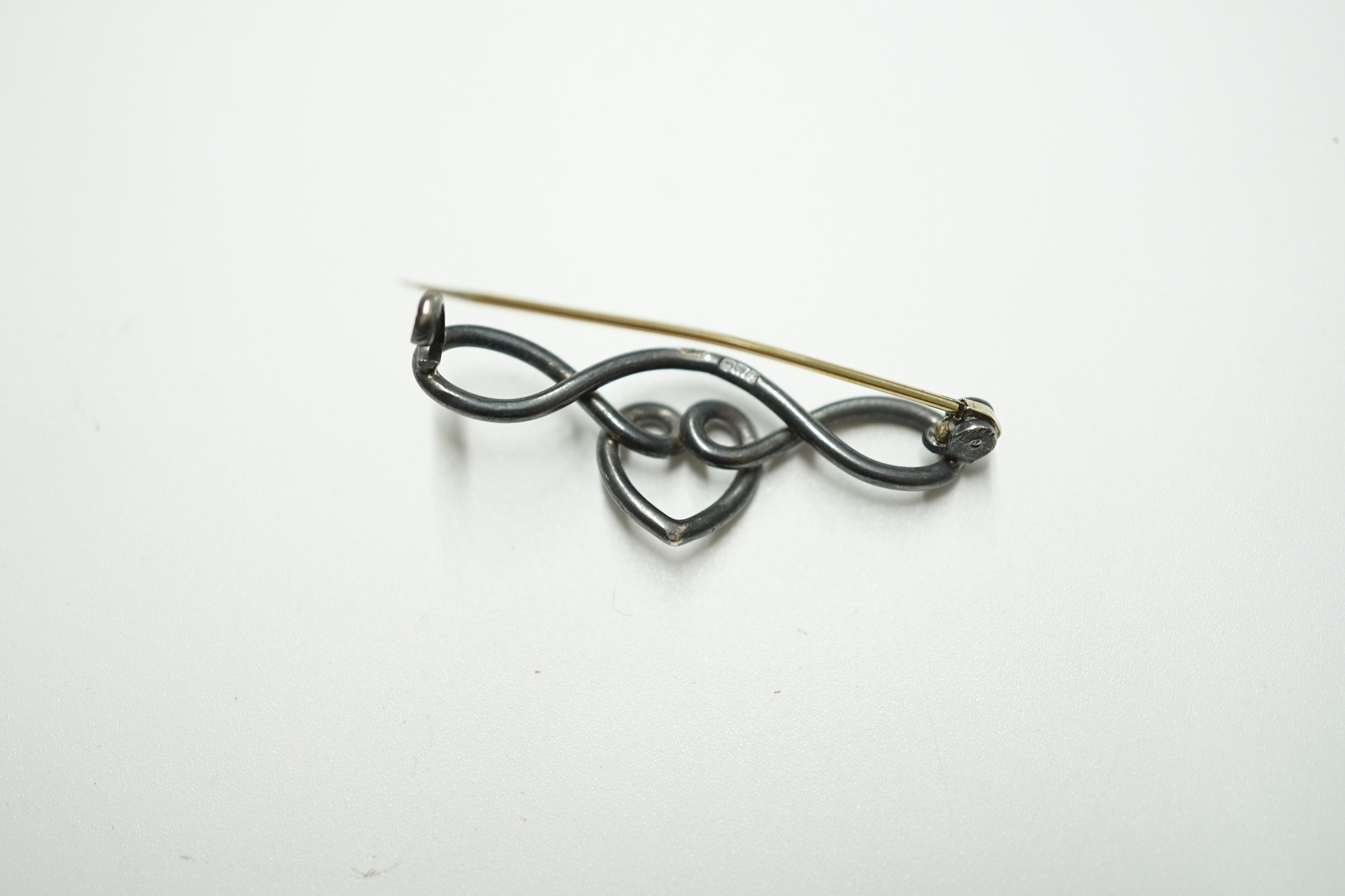 An Edwardian silver heart shaped bar brooch, by Charles Horner, Chester, 1906, 37mm. Condition - fair to good